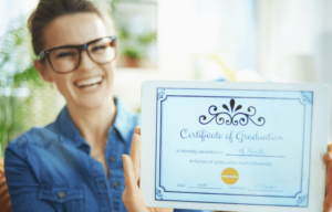 A woman holding up an award certificate.