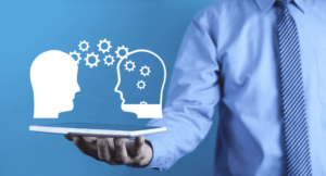 A person holding a tablet with two heads on it